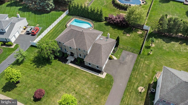 aerial view of property and surrounding area featuring a pool area