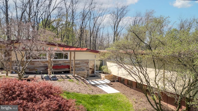 exterior space with stone siding and stucco siding