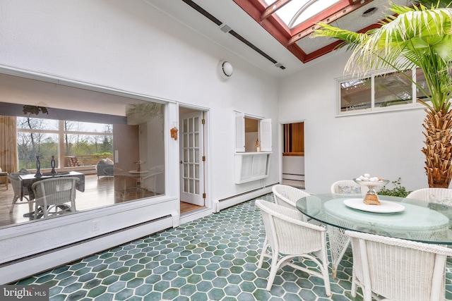 sunroom with a skylight and a baseboard radiator
