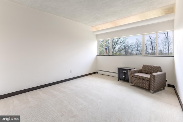 unfurnished room featuring baseboards, light colored carpet, and a baseboard radiator
