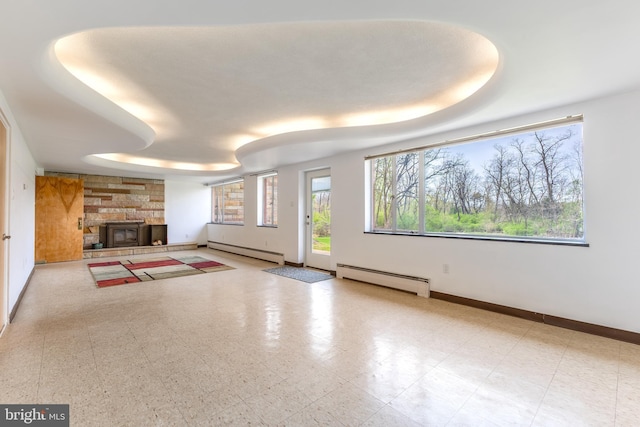 unfurnished living room featuring a baseboard radiator and baseboards