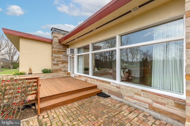 wooden deck with an AC wall unit