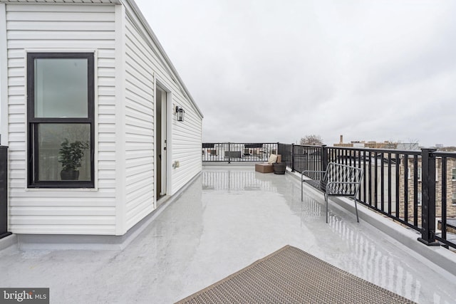 view of patio featuring a balcony