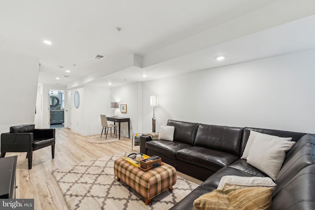 living room with recessed lighting, light wood-type flooring, and visible vents