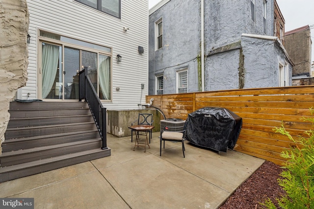 view of patio / terrace with fence, central air condition unit, and a grill