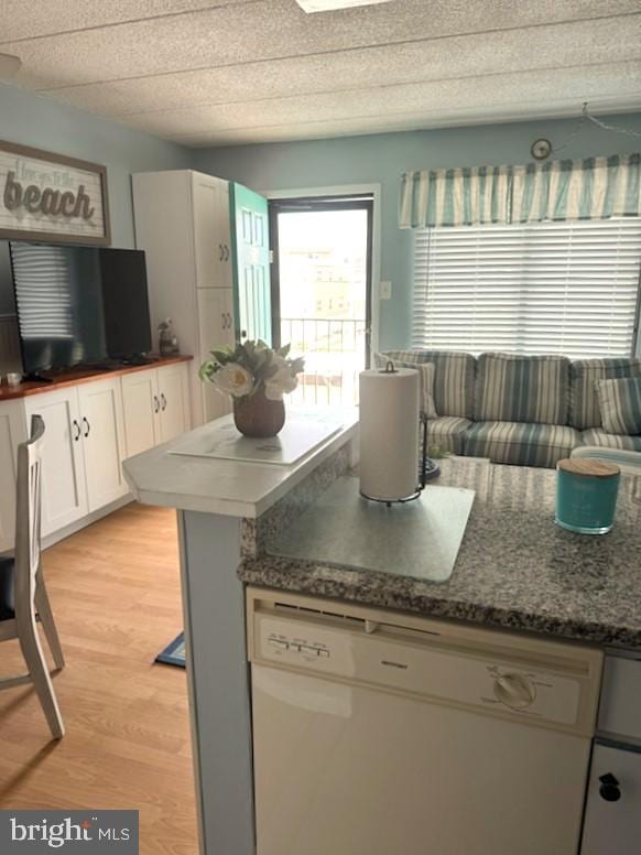 504 E 17th Ave Unit 206, Wildwood, NJ 08260 - kitchen with white cabinets, white dishwasher, and light wood-style flooring