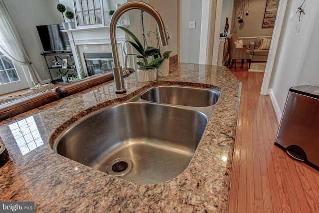33 Brownstone Dr, East Norriton, PA 19401 - room details with stone counters, wood finished floors, a sink, and a tile fireplace
