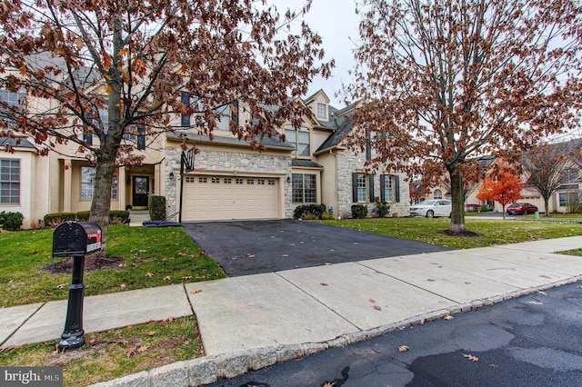 33 Brownstone Dr, East Norriton, PA 19401 - traditional home with stone siding, a front lawn, driveway, and a garage