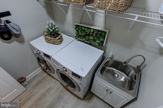 33 Brownstone Dr, East Norriton, PA 19401 - laundry room with light wood finished floors, laundry area, a sink, independent washer and dryer, and baseboards