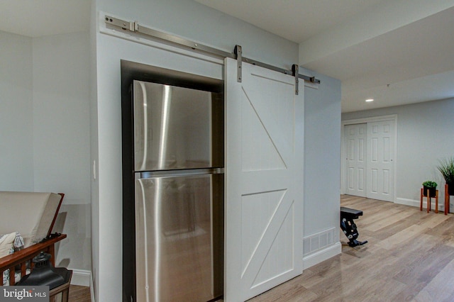 33 Brownstone Dr, East Norriton, PA 19401 - interior space with a barn door, freestanding refrigerator, light wood finished floors, and recessed lighting