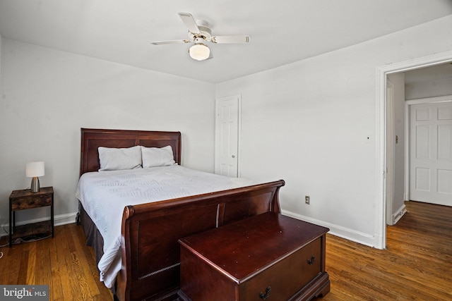 bedroom with ceiling fan, baseboards, and wood finished floors