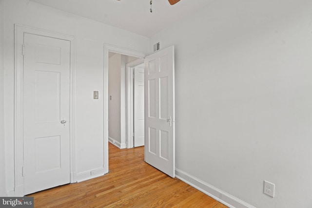 unfurnished bedroom with visible vents, baseboards, and light wood-style floors