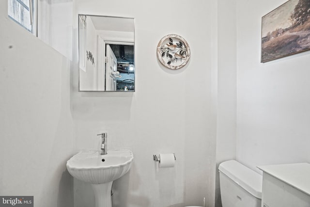 bathroom with toilet and a sink