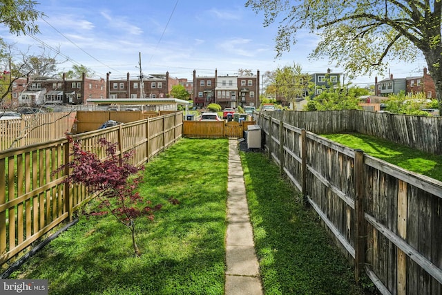 view of yard with a residential view and a fenced backyard