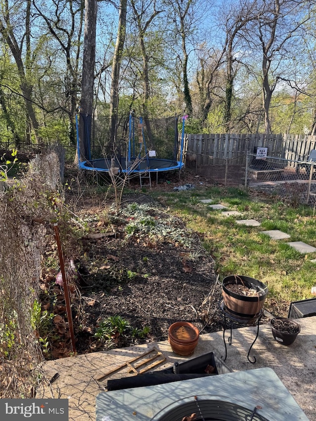 3525 Nottingham Ln, Philadelphia, PA 19114 - view of yard with a trampoline, a patio, a fire pit, and fence