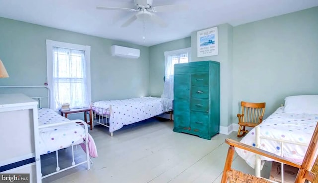 6261 Post Office St, Chincoteague Island, VA 23336 - bedroom with an AC wall unit, baseboards, and a ceiling fan