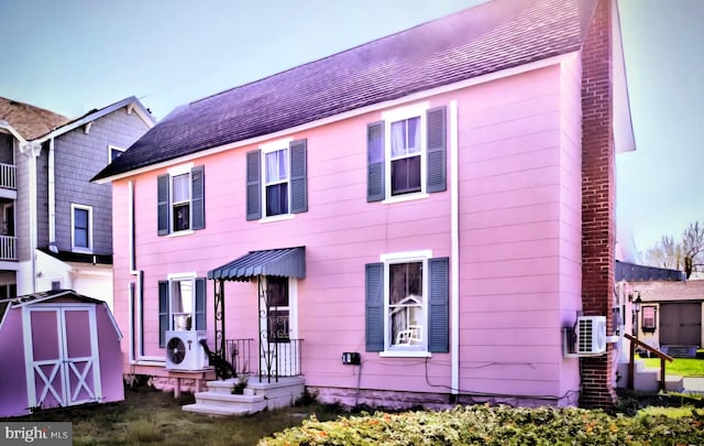 6261 Post Office St, Chincoteague Island, VA 23336 - rear view of house featuring an outdoor structure and a storage unit