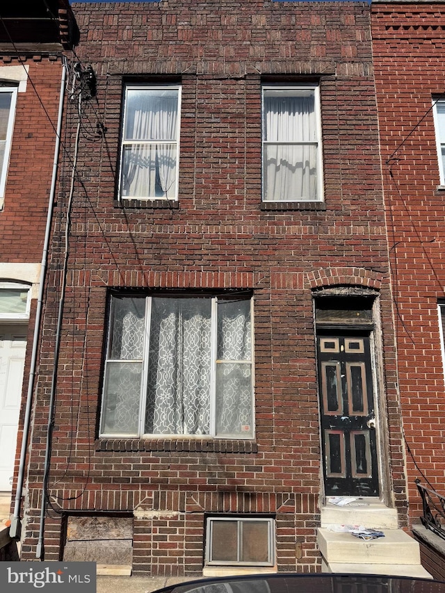 exterior space with brick siding