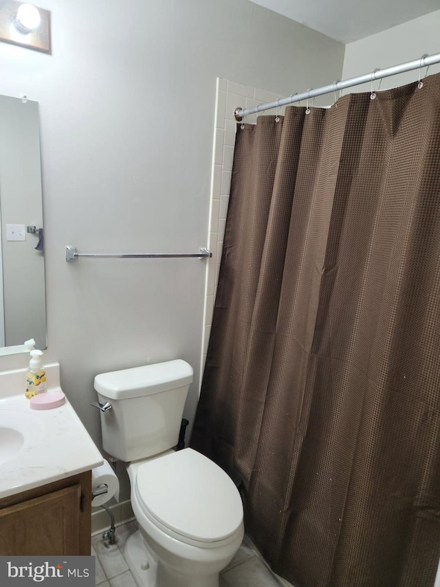 bathroom with tile patterned floors, vanity, a shower with curtain, and toilet