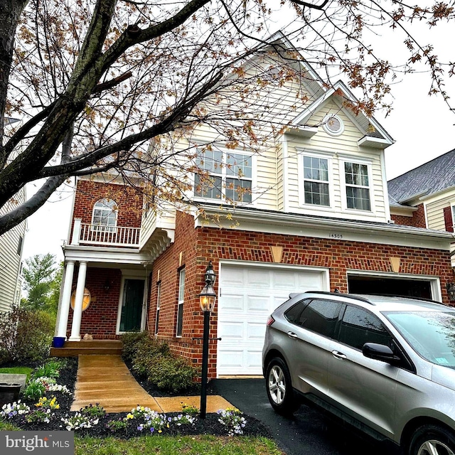 view of front facade with a garage and brick siding