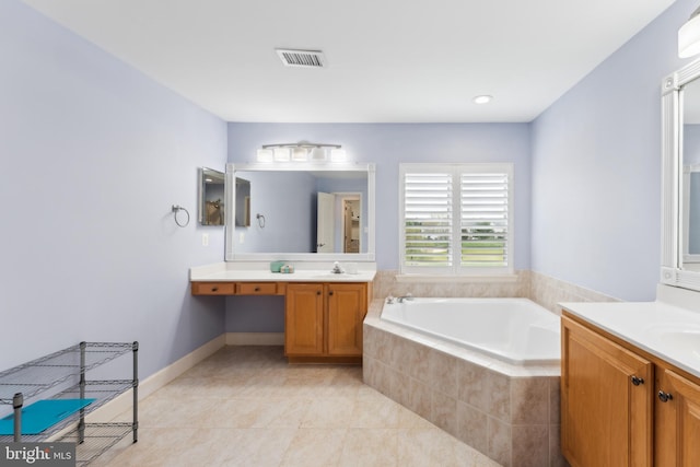 full bathroom featuring a garden tub, tile patterned floors, a sink, two vanities, and visible vents
