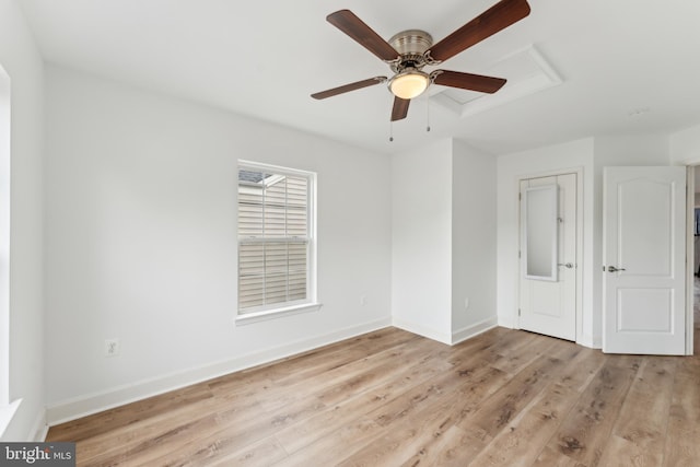 unfurnished bedroom featuring light wood-type flooring, baseboards, and ceiling fan