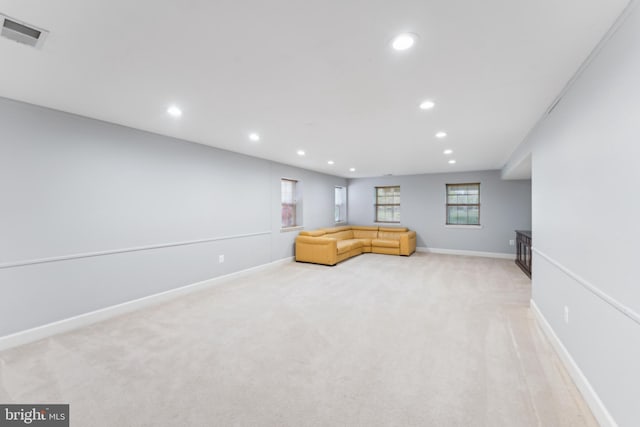 unfurnished living room featuring baseboards, light carpet, visible vents, and recessed lighting
