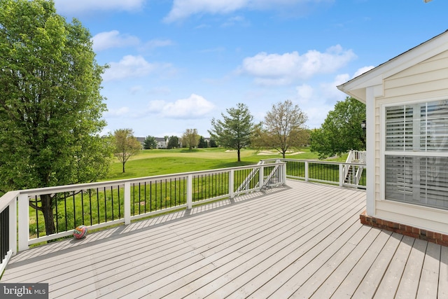 wooden terrace featuring a yard and golf course view