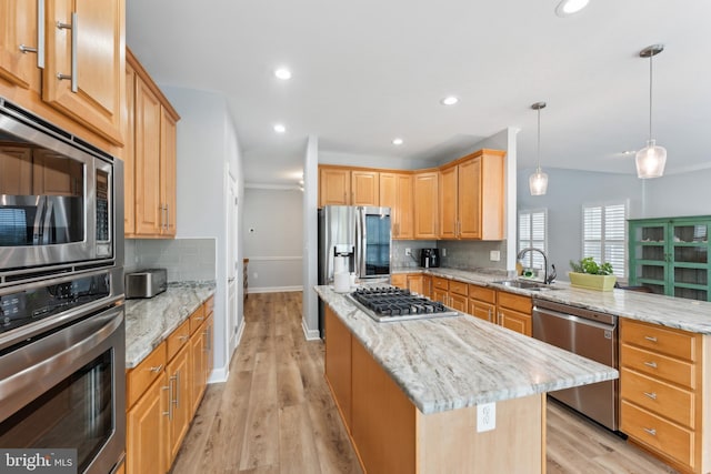 kitchen with decorative backsplash, a center island, stainless steel appliances, and a sink