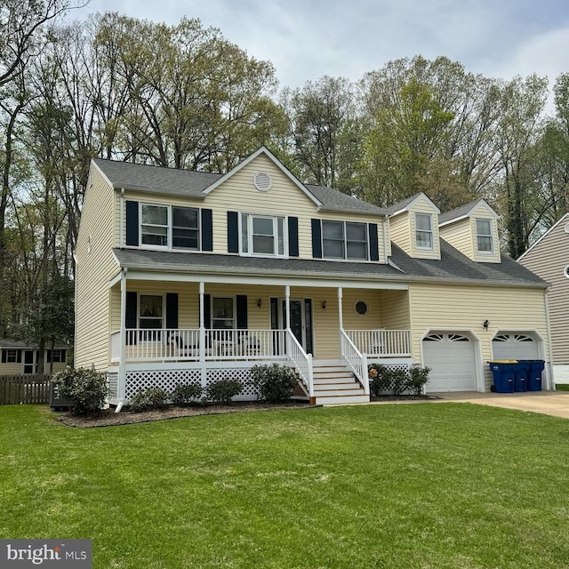 colonial house featuring covered porch, driveway, and a front yard
