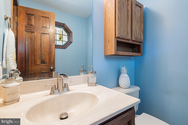bathroom with toilet and vanity