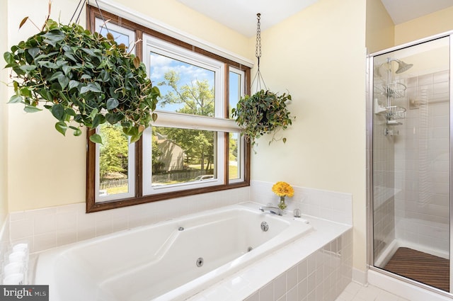 full bath with a tub with jets and a shower stall