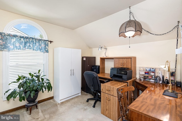 office area with baseboards, light carpet, and lofted ceiling