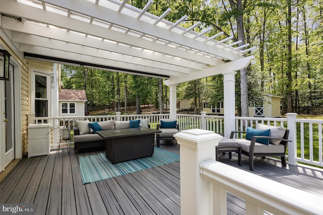 deck featuring an outdoor hangout area, a pergola, and an outdoor structure