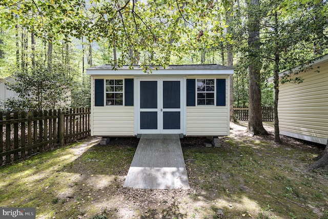 view of shed featuring fence