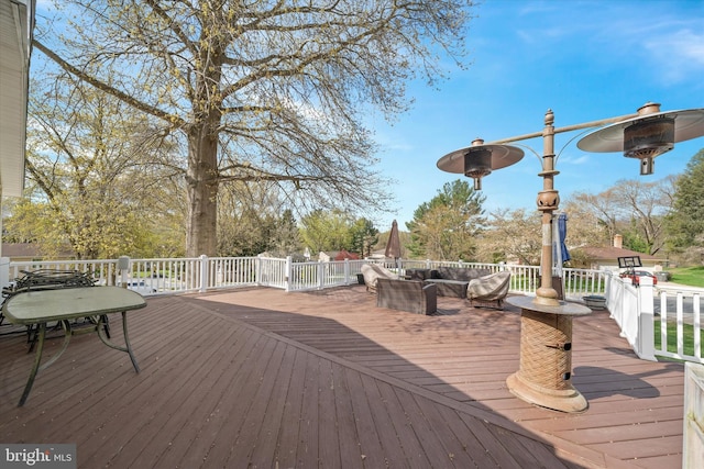 wooden terrace with an outdoor living space
