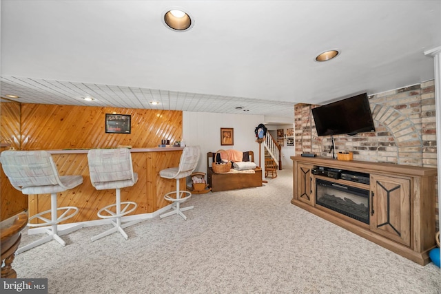 bar featuring stairway, carpet flooring, a dry bar, and wooden walls