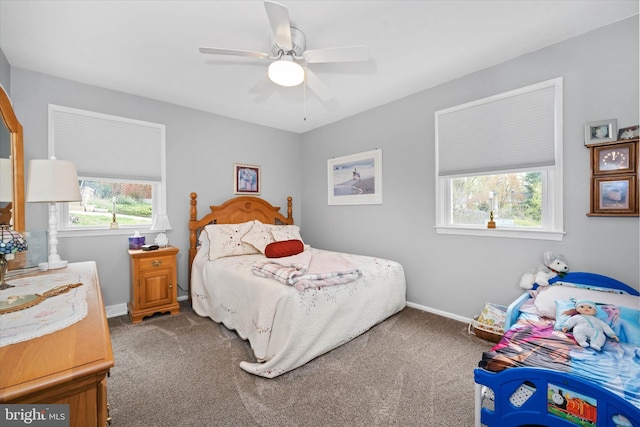 carpeted bedroom featuring baseboards and ceiling fan