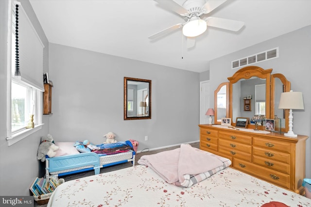 bedroom featuring visible vents, baseboards, and ceiling fan