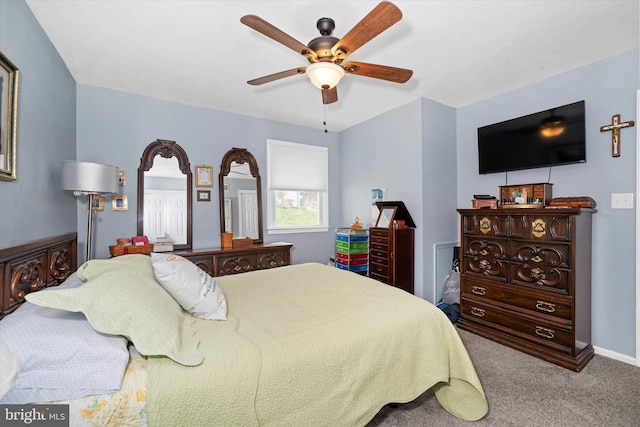 carpeted bedroom featuring ceiling fan and baseboards