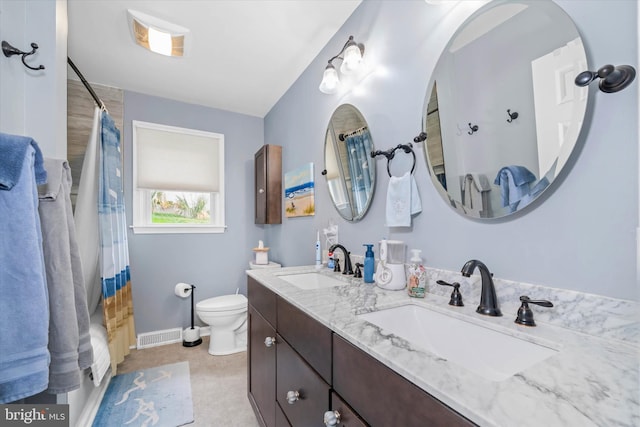 bathroom with visible vents, a sink, a shower with shower curtain, and toilet