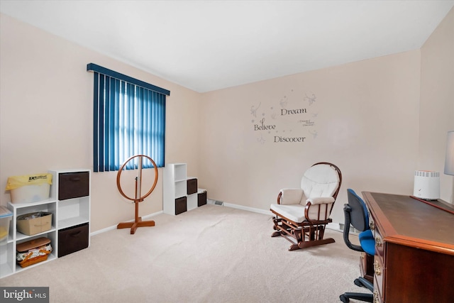 carpeted home office featuring baseboards