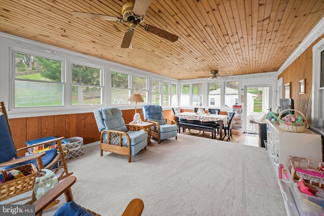 sunroom featuring wood ceiling, a wealth of natural light, and a ceiling fan