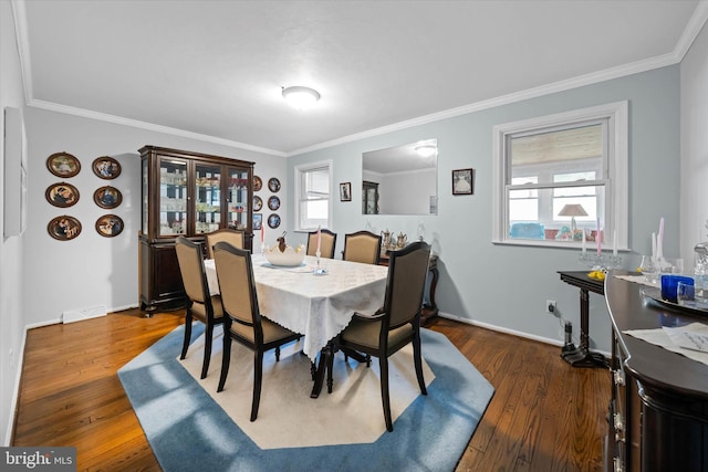 dining room featuring plenty of natural light, visible vents, and crown molding
