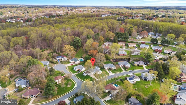 drone / aerial view featuring a forest view and a residential view