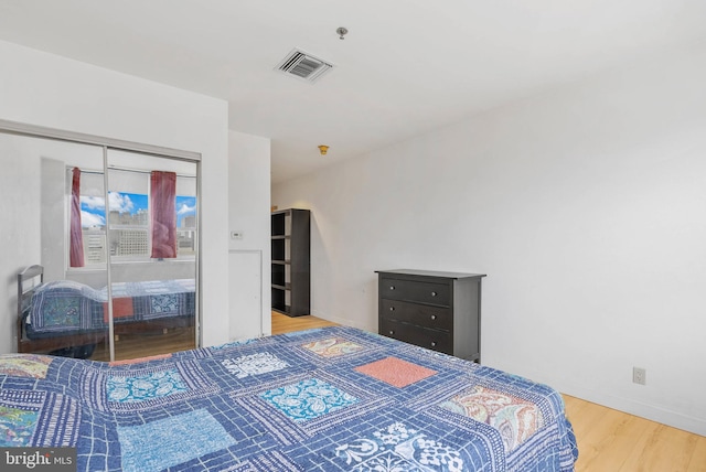 1100 Vine St Unit 1403, Philadelphia, PA 19107 - bedroom with visible vents, a closet, baseboards, and wood finished floors