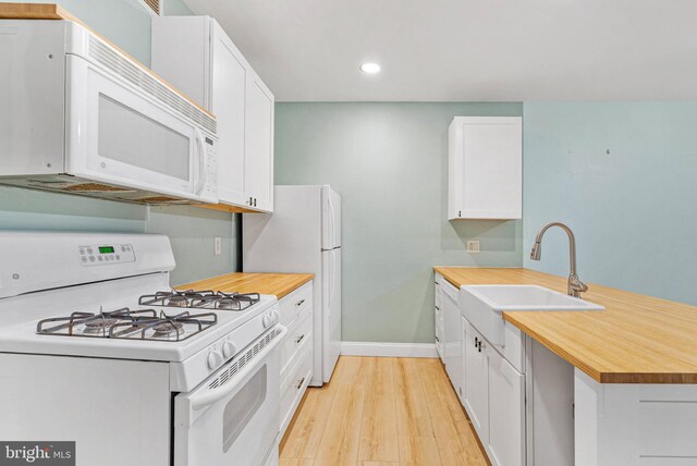 1100 Vine St Unit 1403, Philadelphia, PA 19107 - kitchen featuring baseboards, a sink, white appliances, a peninsula, and recessed lighting