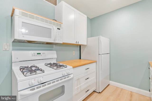 1100 Vine St Unit 1403, Philadelphia, PA 19107 - kitchen with white appliances, light wood-style floors, white cabinetry, and baseboards