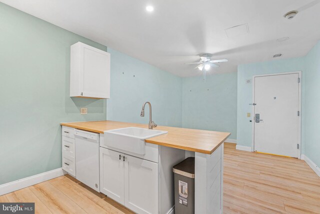 1100 Vine St Unit 1403, Philadelphia, PA 19107 - kitchen featuring a peninsula, white cabinetry, light wood-style floors, dishwasher, and a sink