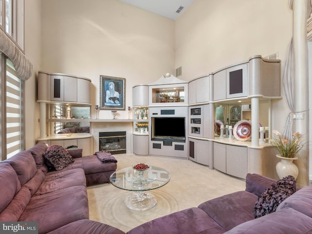 28 Vanessa Ct, Cherry Hill, NJ 08003 - living room with a high ceiling, a glass covered fireplace, and light carpet